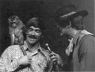Larry Nunley 'escorts' a squirrel monkey onto the show